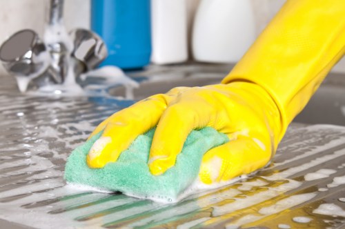 Trained carpet cleaning technician using safe working practices in a home